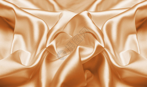 黄银小耳戒金色丝绸背景设计图片