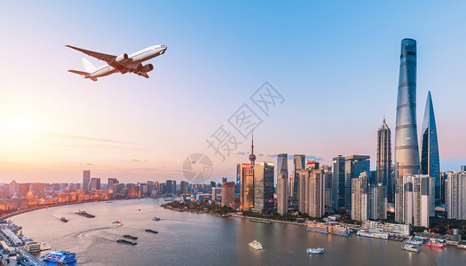 城市上空的飞机背景图片