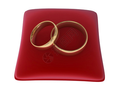 红枕上的两枚结婚戒指图片