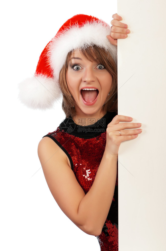 情感美丽的圣诞女孩戴着圣诞老人的帽子图片