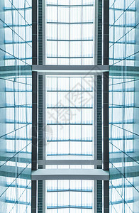 通过蓝色玻璃的现代天窗查看具有方形对称截面的建筑物屋顶现代建筑图片