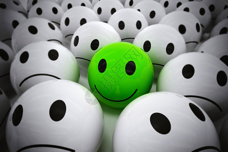 3D带着笑脸的绿色球在如此众多的白色悲哀球中诞生快乐的领导者支持图片