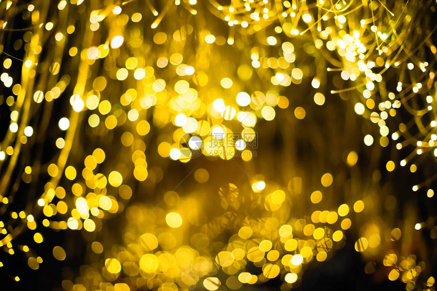 金抽象景背圣诞节背景带有散景焦灯和星的图片