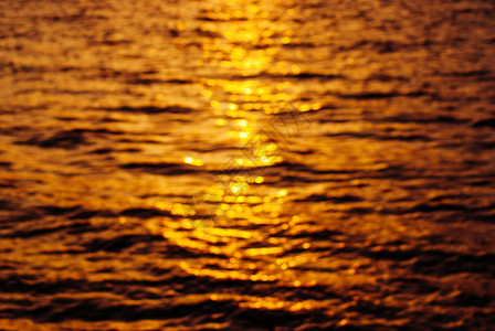 模糊的抽象背景日落时的水纹理太阳在海图片
