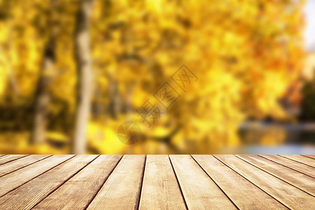 秋天背景模糊的木质桌顶秋天金色抽象背图片