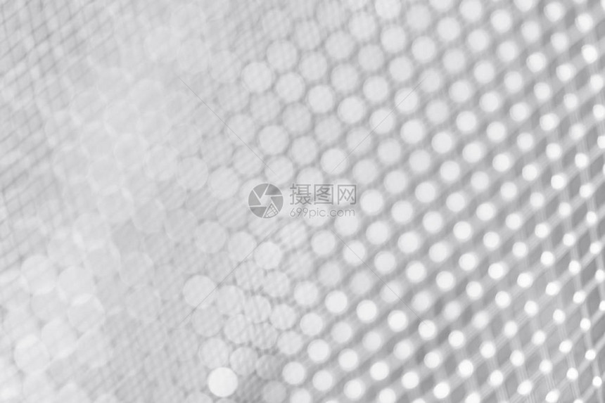 蜂窝形式的不锈钢模糊纹理的一部分抽象的银灰色板模糊的背景网格地板具有景深的照片灰色金属图片