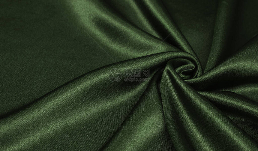 优雅的绿色丝绸或席恩奢侈布质素可用作抽象背景卷起的织图片