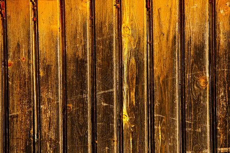 带有结和钉孔的复古棕色木材背景纹理旧漆木墙棕色抽象背景老式木制深色水平板带有复制背景图片