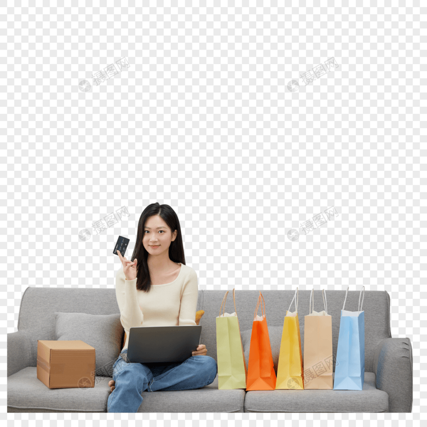 沙发上拿着购物卡与电脑的女性图片