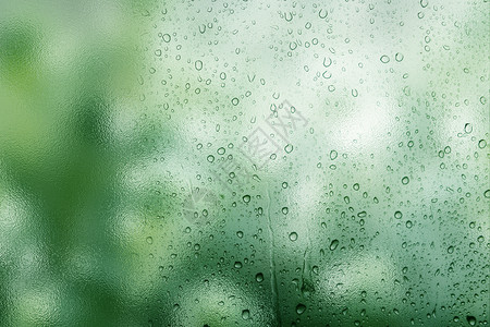 窗外的雨滴唯美绿色雨滴背景设计图片