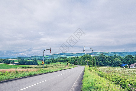 北海道夏天晴空远路和骑车少年背景