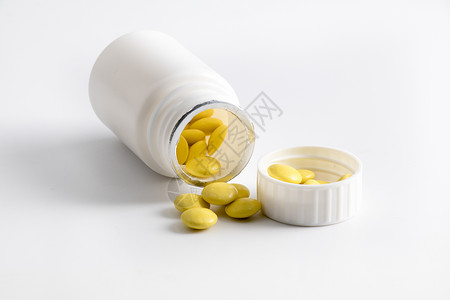 黄色药片药罐子糖衣的高清图片