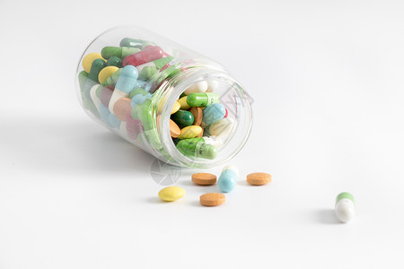 保健品包装设计透明药瓶中散落的药背景