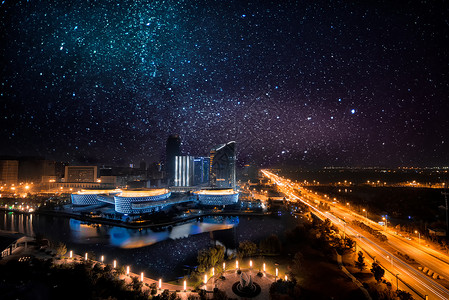 蓝紫梦幻光效星空下的城市夜景背景