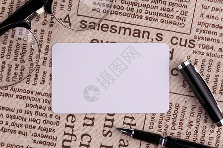 多彩商业卡片眼镜钢笔和报纸背景