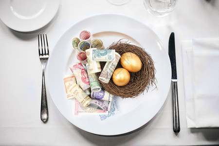 现金大的纸钞金蛋成为盘中餐设计图片