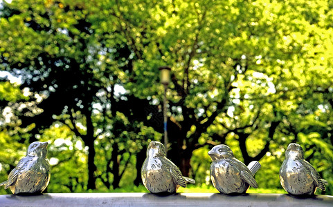 日本大阪城公园里的绿树下的鸟儿雕塑图片