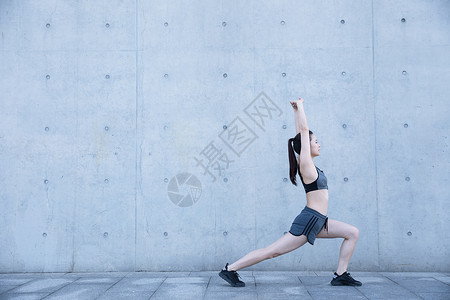 户外运动女孩热身压腿伸展背景图片