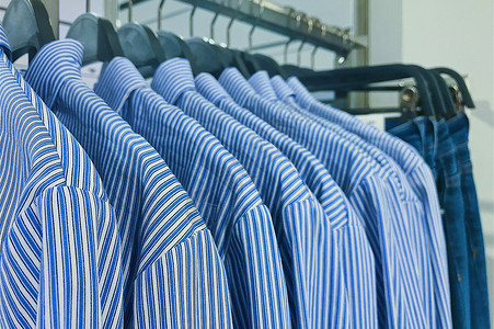 蓝色条纹背景商城女装店整齐排列的条纹衬衫背景
