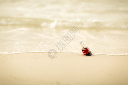 沙滩上的可乐瓶图片
