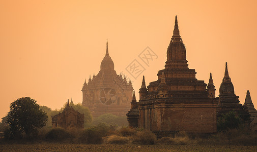 缅甸人文缅甸日出中的一座佛塔背景