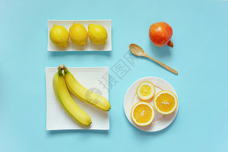 柠檬黄背景摆放的水果素材背景