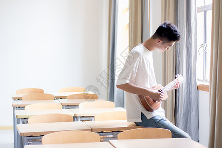 教室里弹尤克里里的男同学图片