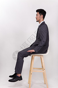 坐在椅子上伸懒腰的商务男士坐在椅子上的商务人士背景