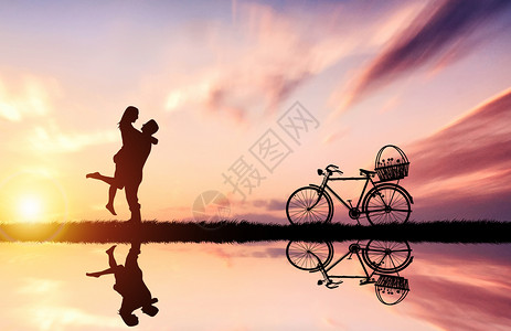 自行车的剪影夕阳下的情侣背景