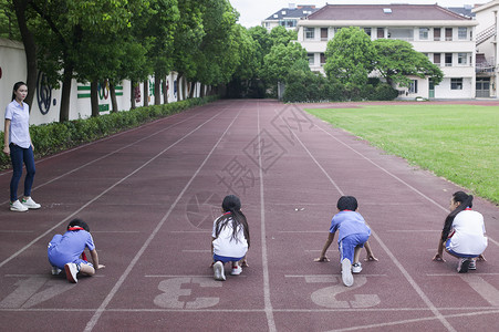 赢在起点男女同学在操场跑道上比赛跑步背景