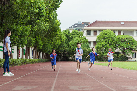 开心女老师老师看孩子们在操场上奔跑背景