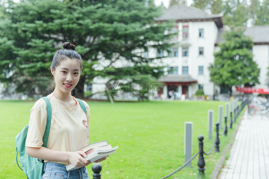 校园里抱着书本的女生图片