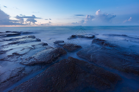 五彩滩日落涠洲岛五彩滩的日出背景