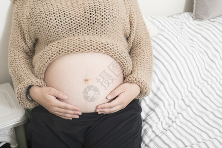 大肚子卡通孕妇照肚子特写背景