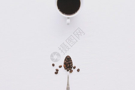 银勺子咖啡和咖啡豆摆放背景