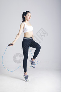 背心美女跳绳运动的健身女性背景