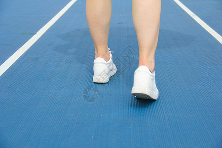 跑步球鞋操场跑道的腿部特写背景