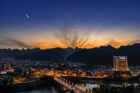 荔波喀斯特城市夜景日落月亮背景