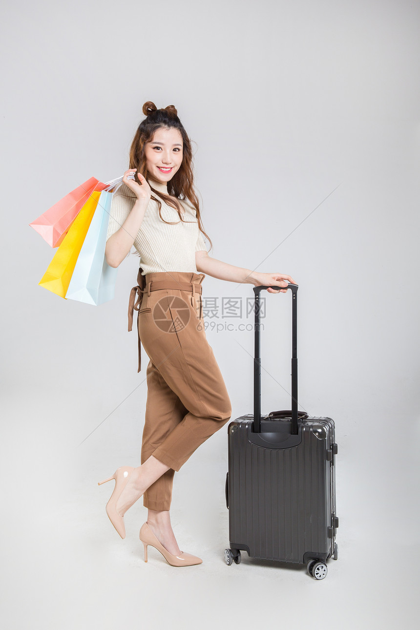 推行李箱购物的时尚女性图片