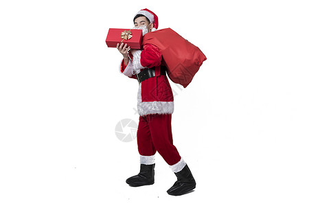 圣诞老人背礼物包裹背景图片