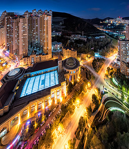 场馆照明鸟瞰大连游泳馆城市夜景背景