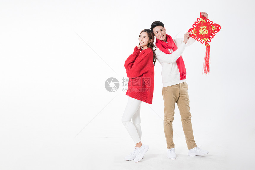 年轻夫妻拿着新年中国结图片