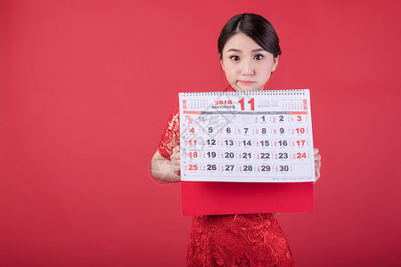 11月您好新春手持日历的东方美女背景