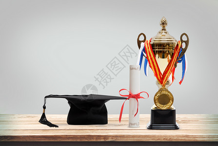学士帽和奖杯背景图片