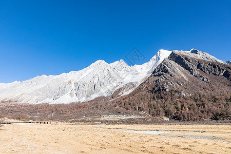 冰川泥冬天的稻城亚丁雪山背景