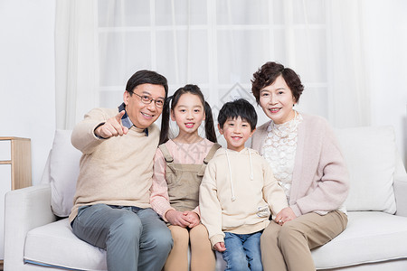 小孩子幸福地和爷爷奶奶在客厅背景图片