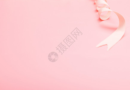 粉色背景丝绸缎带静物背景图片