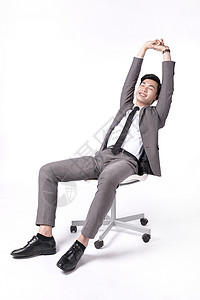 商务人士坐在椅子上坐在椅子上伸懒腰的商务男士背景