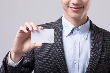 销售卡年轻商务男性手持名片背景