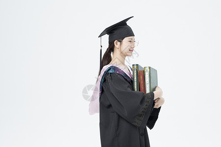 拿着书本的毕业女大学生图片